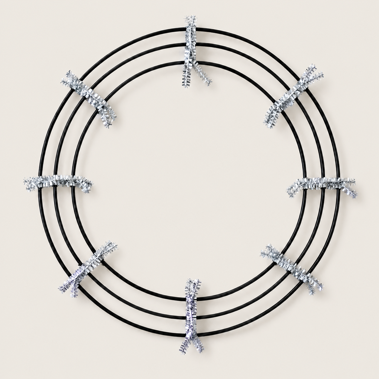 18-inch black wire wreath frame prepared with silver pipe cleaners for a DIY Halloween wreath.